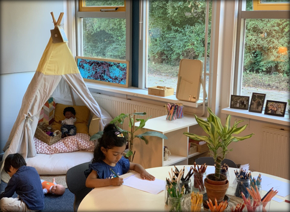 A calm classroom with neutral colours, natural elements and purposefully placed learning materials